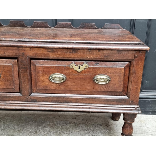 1098 - An 18th century oak two drawer side table, 131cm wide, (alterations).