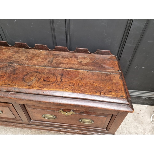 1098 - An 18th century oak two drawer side table, 131cm wide, (alterations).