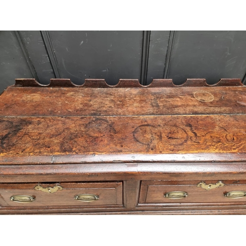 1098 - An 18th century oak two drawer side table, 131cm wide, (alterations).