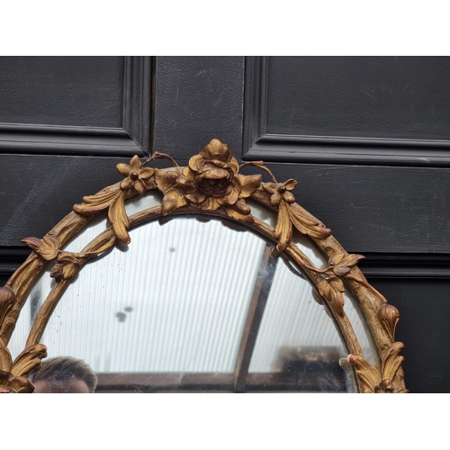 1122 - A 19th century gilt framed oval wall mirror, with trailing foliage, 51 x 42.5cm. ... 