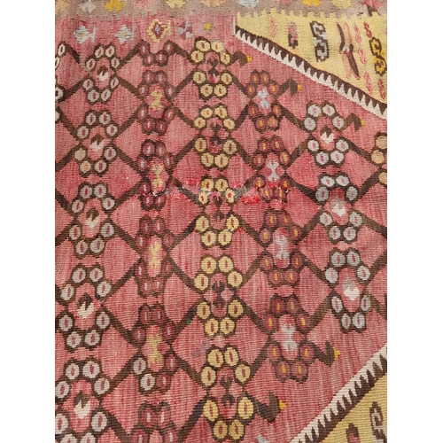 1126 - A flatweave rug, having floral and geometric borders 200 x 136cm; together with a Kelim rug; and a s... 