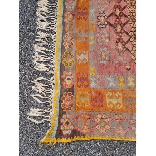 1126 - A flatweave rug, having floral and geometric borders 200 x 136cm; together with a Kelim rug; and a s... 