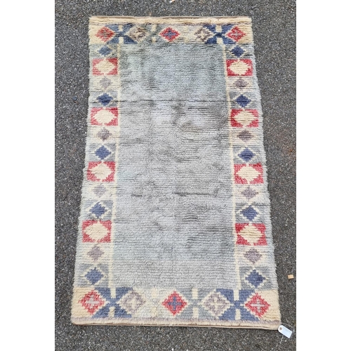 1127 - A Swedish rag rug, having geometric borders, 192 x 108cm.