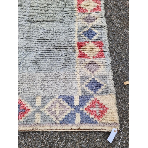 1127 - A Swedish rag rug, having geometric borders, 192 x 108cm.