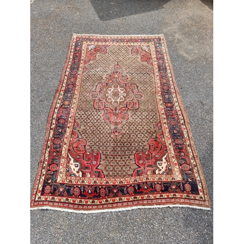 1131 - A Persian rug, having central floral medallion, with geometric floral cartouches to each corner, wit... 