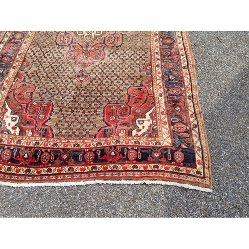 1131 - A Persian rug, having central floral medallion, with geometric floral cartouches to each corner, wit... 