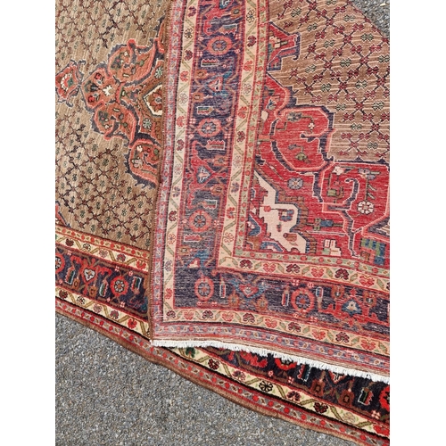 1131 - A Persian rug, having central floral medallion, with geometric floral cartouches to each corner, wit... 