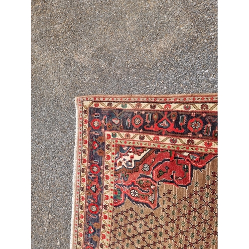 1131 - A Persian rug, having central floral medallion, with geometric floral cartouches to each corner, wit... 