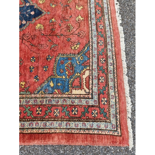 1132 - A Persian style rug, having central floral medallion, with floral cartouches to each corner, 255 x 1... 