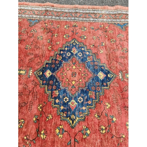 1132 - A Persian style rug, having central floral medallion, with floral cartouches to each corner, 255 x 1... 