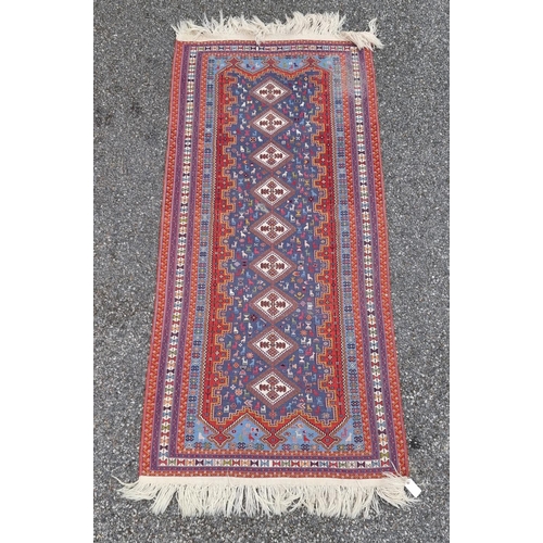 1133 - A Kelim rug, having nine central medallions, central field decorated with animals, 210 x 100cm.... 