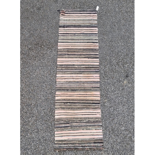 1138 - A Swedish rag rug, having allover geometric pattern, 220 x 65cm.