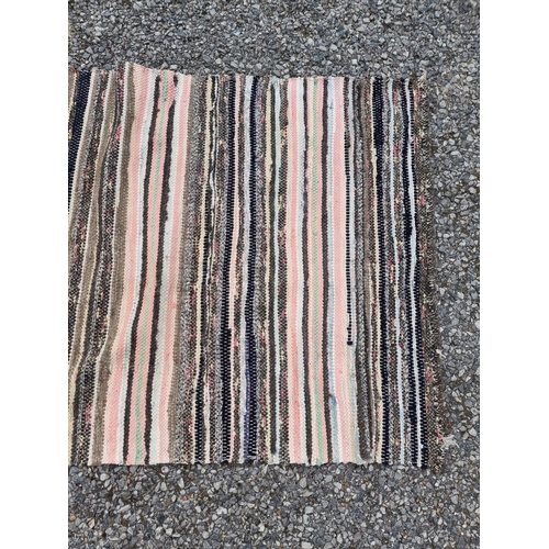 1138 - A Swedish rag rug, having allover geometric pattern, 220 x 65cm.