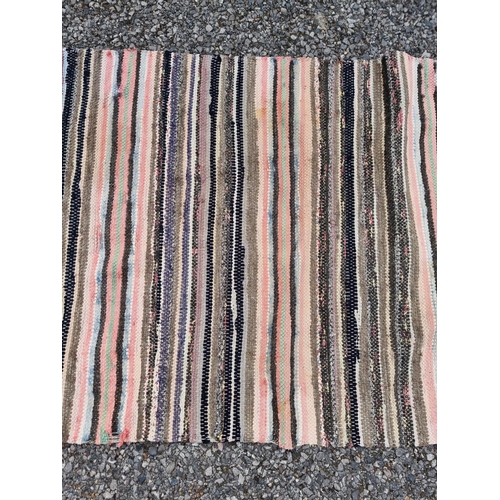 1138 - A Swedish rag rug, having allover geometric pattern, 220 x 65cm.