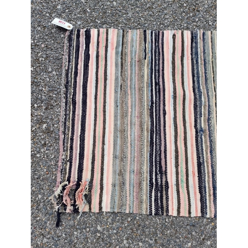 1138 - A Swedish rag rug, having allover geometric pattern, 220 x 65cm.