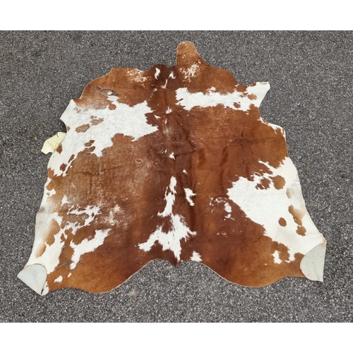 1142 - An old cow hide rug, 184cm long x 202 wide.