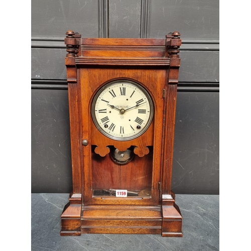 1159 - A late 19th century American walnut mantel clock, 53.5cm high, with pendulum.