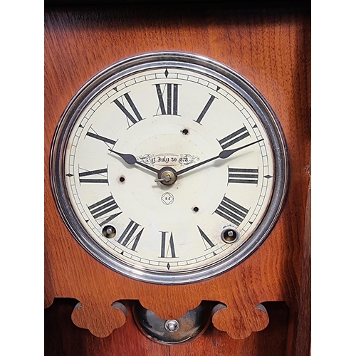 1159 - A late 19th century American walnut mantel clock, 53.5cm high, with pendulum.