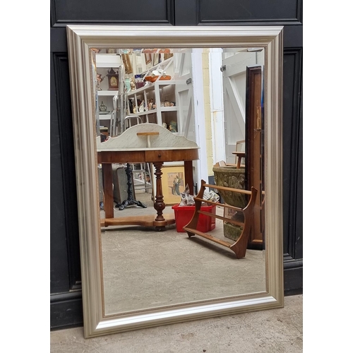 1165 - A modern silvered frame rectangular wall mirror, 94cm x 130cm.