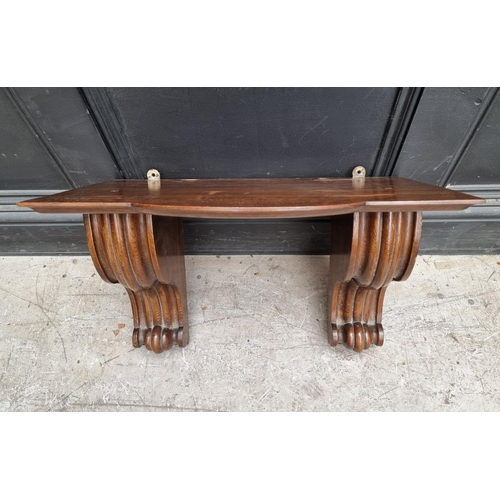 1240 - A large oak clock bracket, 34cm high x 53.5cm wide.