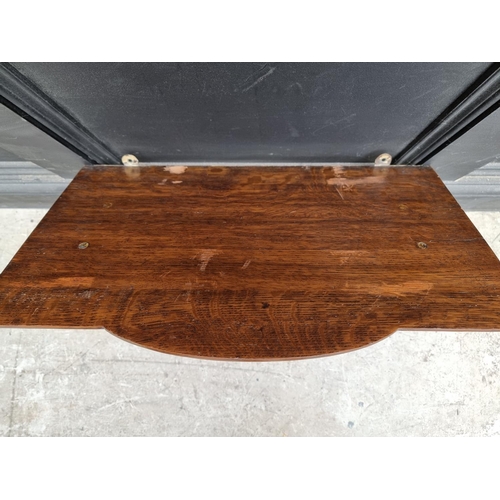 1240 - A large oak clock bracket, 34cm high x 53.5cm wide.