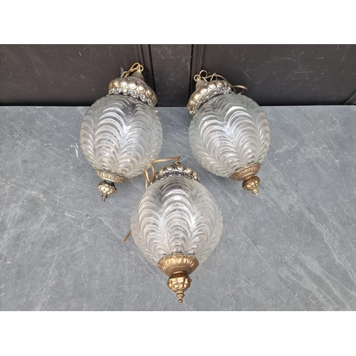 1247 - A set of three moulded glass and brass ceiling lanterns, approx 35cm high.