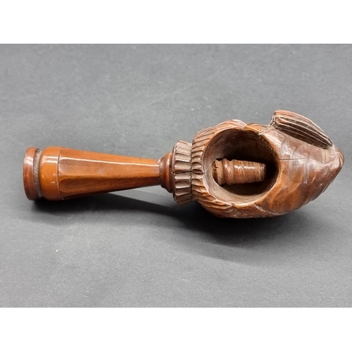 1627 - A 19th century Continental carved walnut novelty nutcracker, 15.5cm long.