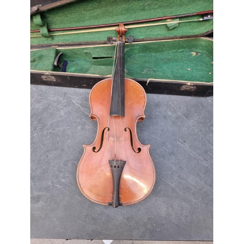 1644 - An antique Continental violin, with 14in two-piece back, with bow, in ebonised case.... 