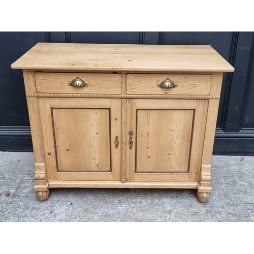 1053 - A 19th century continental pine side cabinet, 109cm wide.