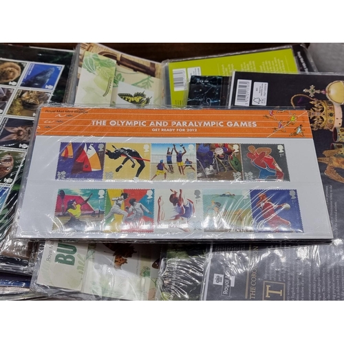 214 - MINT STAMPS: a quantity in original packaging. (Box)