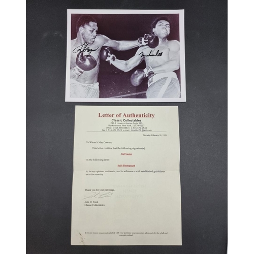 242 - MUHAMMAD ALI/JOE FRAZIER: a photographic print of Ali and Frazier in the ring, signed by both i... 