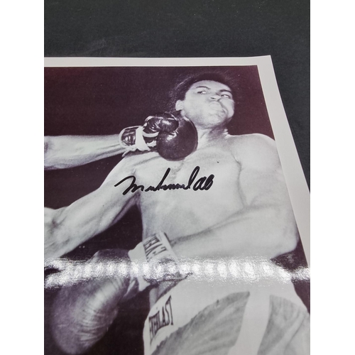 242 - MUHAMMAD ALI/JOE FRAZIER: a photographic print of Ali and Frazier in the ring, signed by both i... 