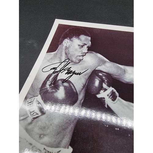 242 - MUHAMMAD ALI/JOE FRAZIER: a photographic print of Ali and Frazier in the ring, signed by both i... 