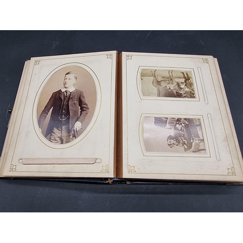 36 - CARTE DE VISITE ALBUM: a mid-Victorian album containing numerous window mounted cdv & cabinet ca... 