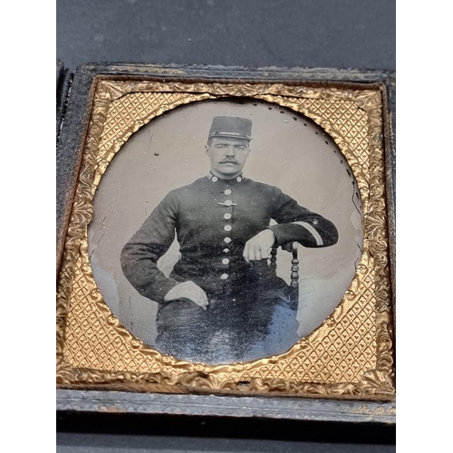 57 - AMBROTYPE: cased portrait of uniformed man seated, metallic closure partially lacking, old repa... 