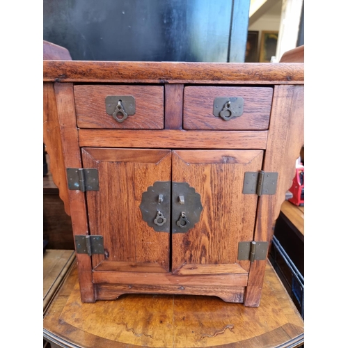 1015 - A miniature Chinese pine altar cabinet, 45cm high x 50cm wide.