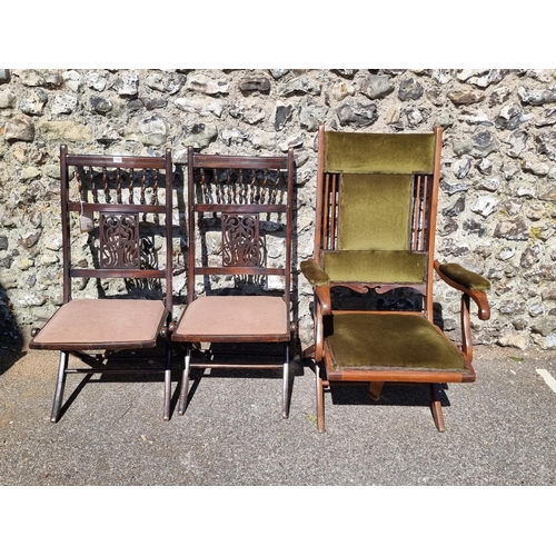 1107 - An Edwardian mahogany and upholstered folding steamer chair; together with another similar pair. (3)... 