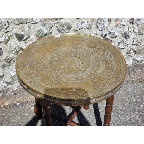 1111 - A brass top folding occasional table, 60cm diameter.