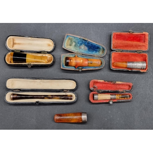 1636 - A collection of vintage cheroot and cigar holders, to include tortoiseshell and amber examples, one ... 