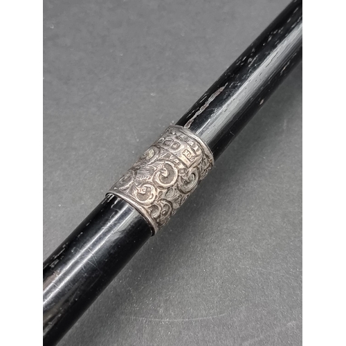 1648 - An ebonised and silver mounted conductor's baton, inscribed 'Presented to Miss L G Griffiths, by Her... 