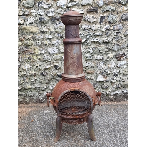 1664 - A cast iron chimenea, 122cm high.