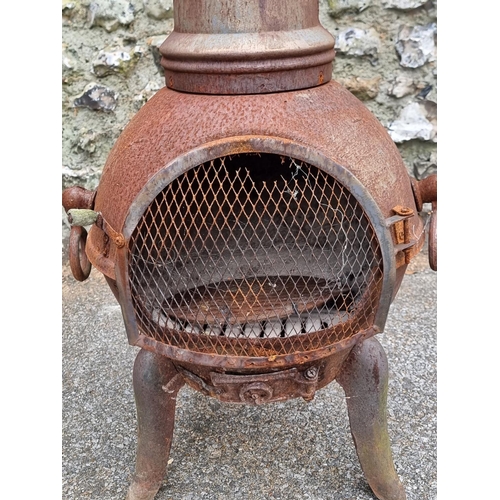 1664 - A cast iron chimenea, 122cm high.