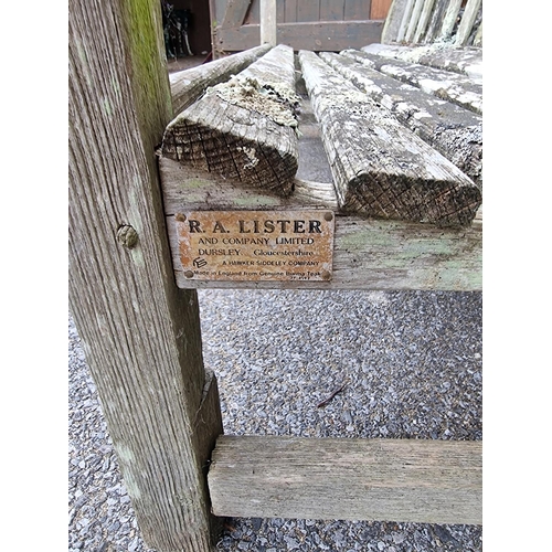 1673 - A weathered teak garden bench, by Lister, 152.5cm wide, (a.f.).