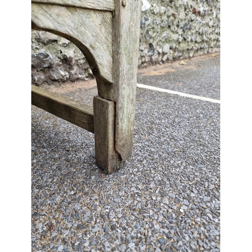 1673 - A weathered teak garden bench, by Lister, 152.5cm wide, (a.f.).