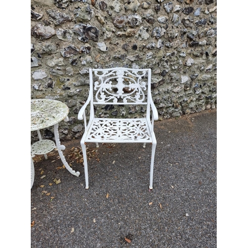 1675 - A pair of white painted cast iron garden chairs; and a similar circular table, 45cm diameter. (3)... 