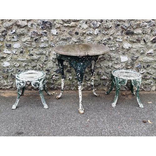 1678 - An old cast iron pub table; together with two small painted garden tables. (3)