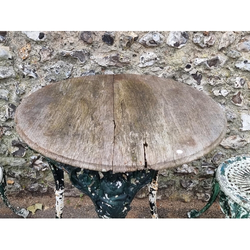 1678 - An old cast iron pub table; together with two small painted garden tables. (3)