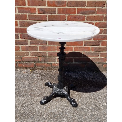 1660 - A cast iron and marble top cafe table, 70cm high x 60.5cm diameter.