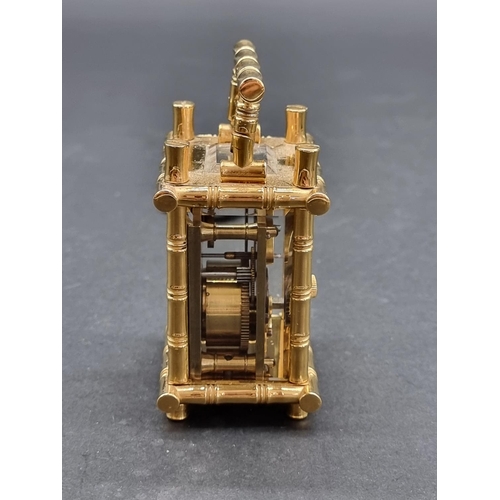 1147 - A small brass simulated bamboo carriage timepiece, height including handle 9.5cm, with winding key.... 