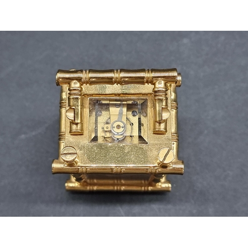 1147 - A small brass simulated bamboo carriage timepiece, height including handle 9.5cm, with winding key.... 